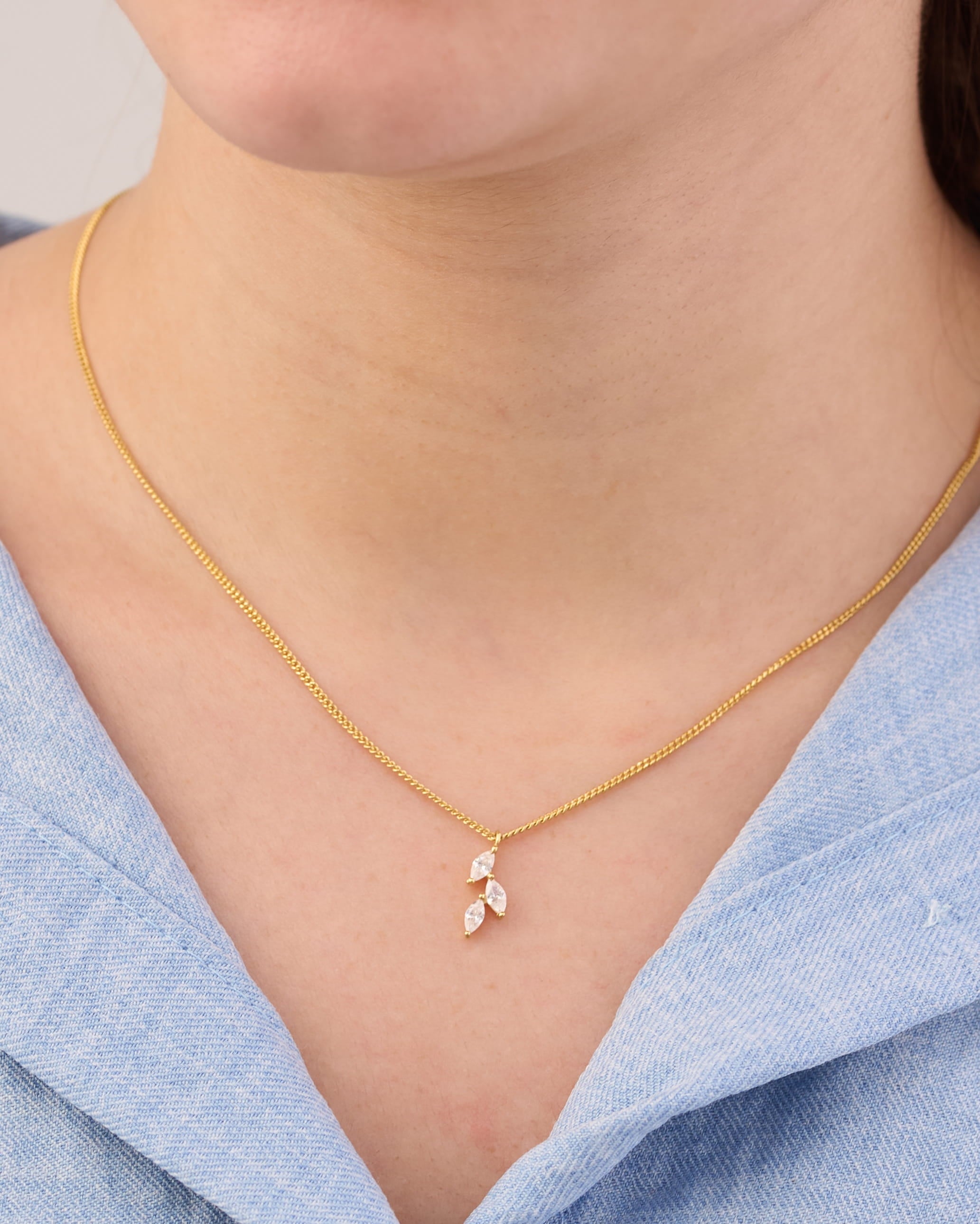 Stainless steel gold-tone dainty leaf crystal pendant necklace worn on neck