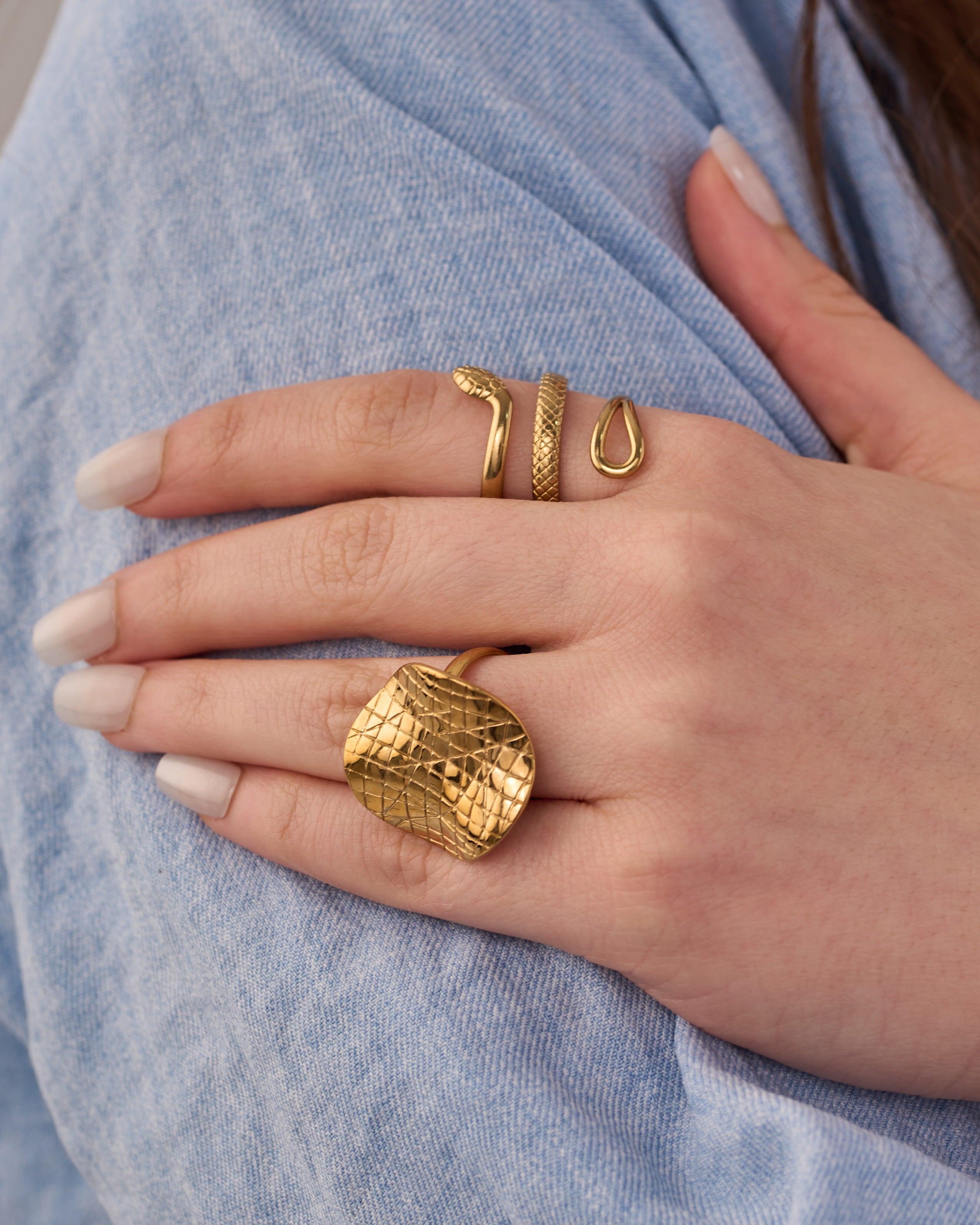 Stainless steel gold-tone snake ring and chunky crocodile textured statement ring set on hand