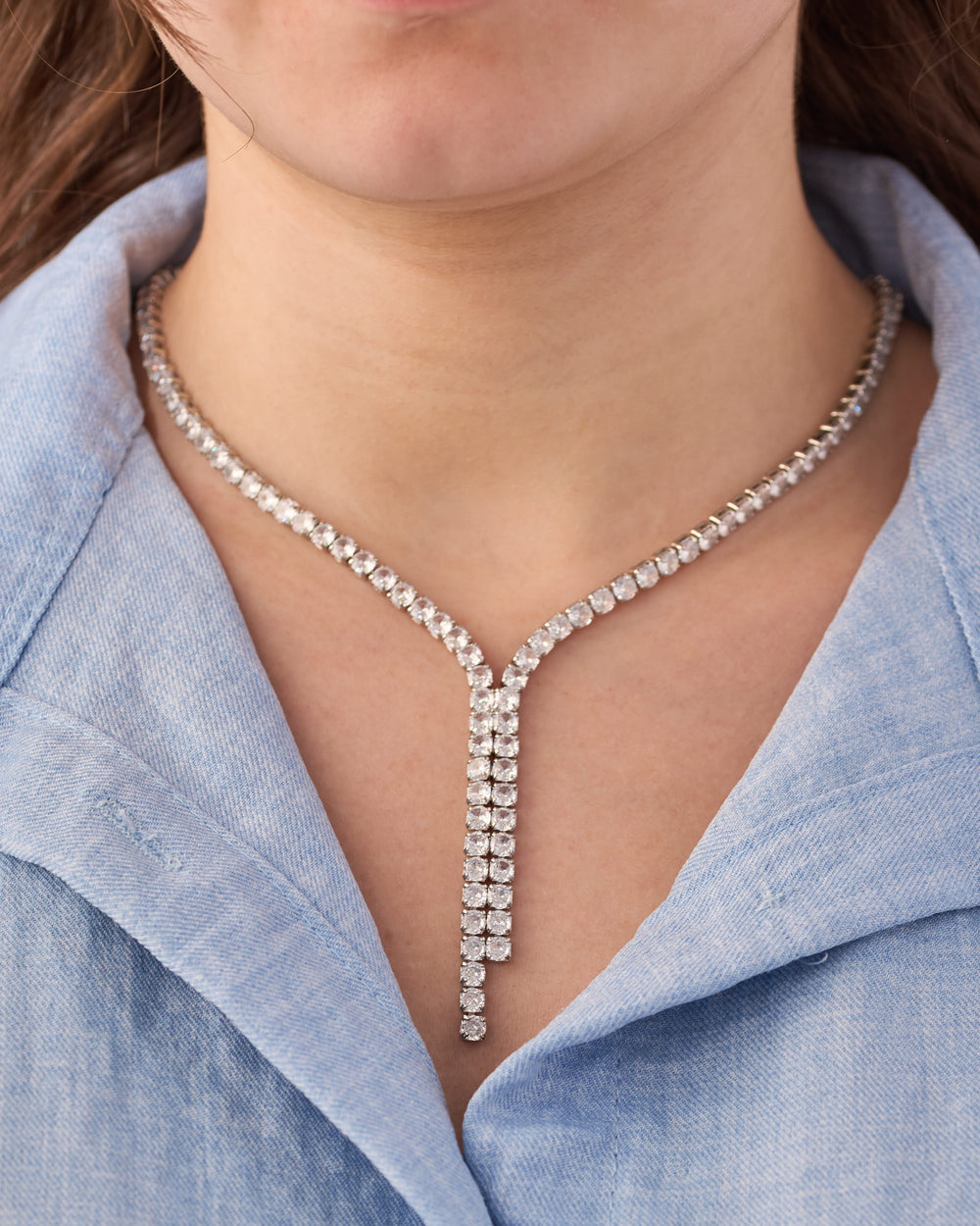Close-up of stainless steel crystal Y-drop lariat necklace with round-cut stones