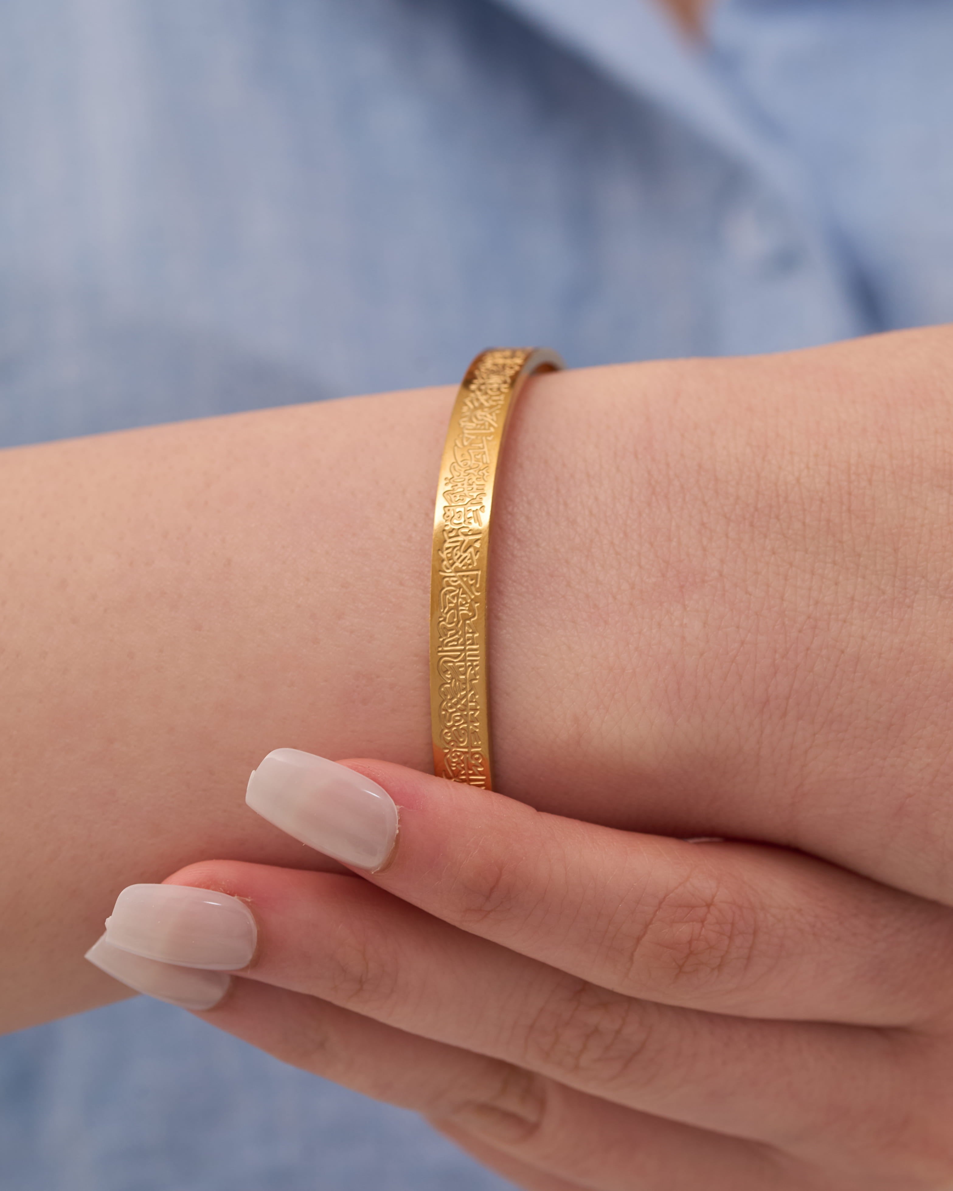 Stainless steel gold-tone textured cuff bangle bracelet on wrist