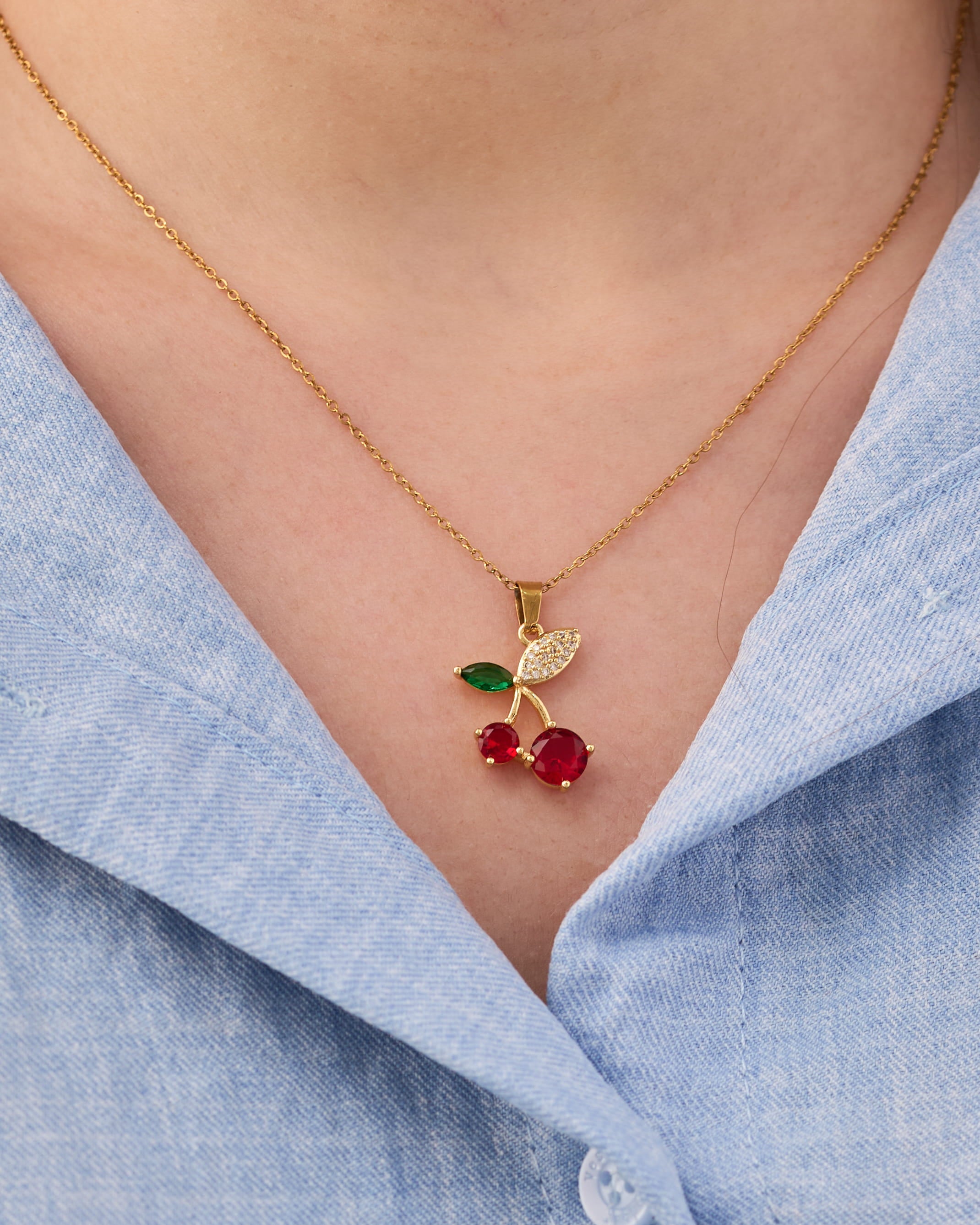 Stainless steel gold-tone cherry pendant necklace with red crystal and green enamel leaf details