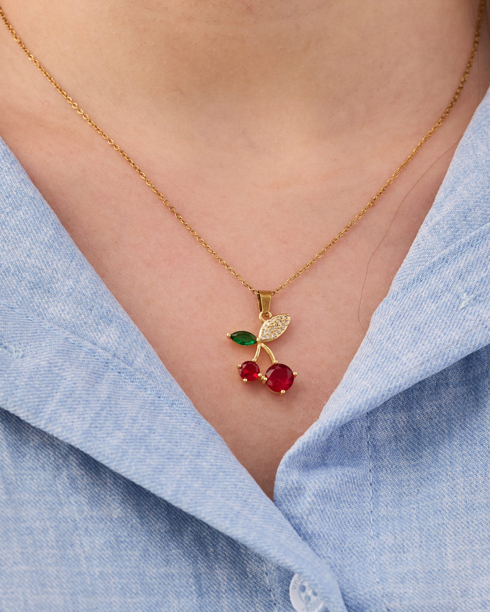 Stainless steel gold-tone cherry pendant necklace with red crystal and green enamel leaf details
