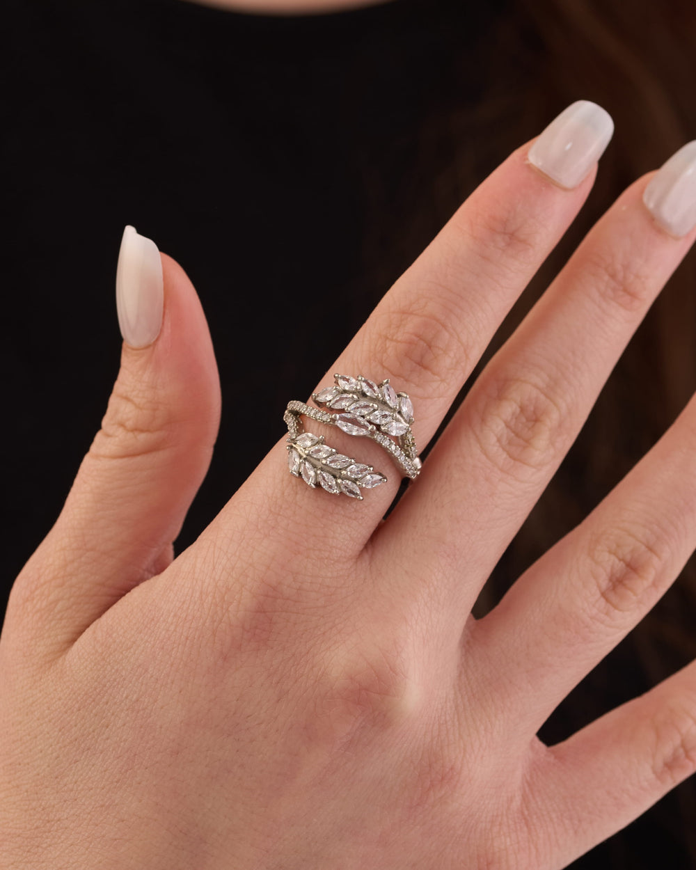 Stainless steel silver-tone crystal-encrusted leaf wrap statement ring worn on finger